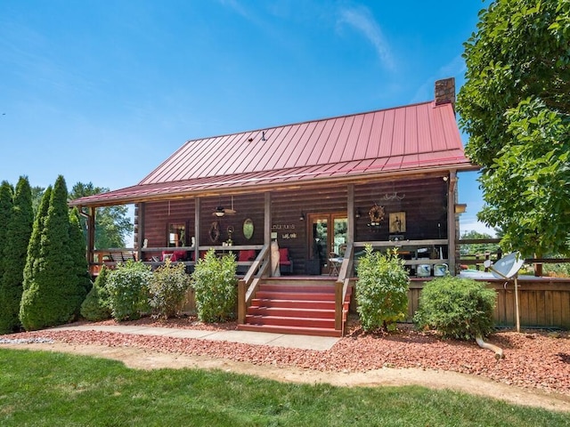 back of property with a porch