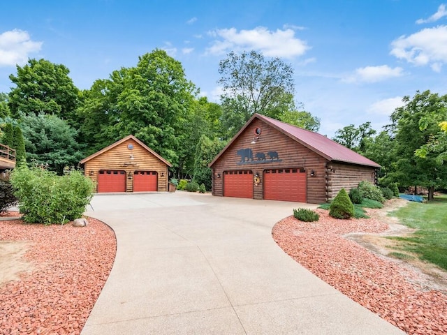 view of front of property featuring a garage and an outbuilding