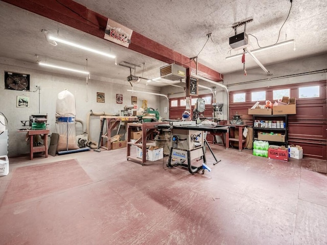 garage with a workshop area and a garage door opener