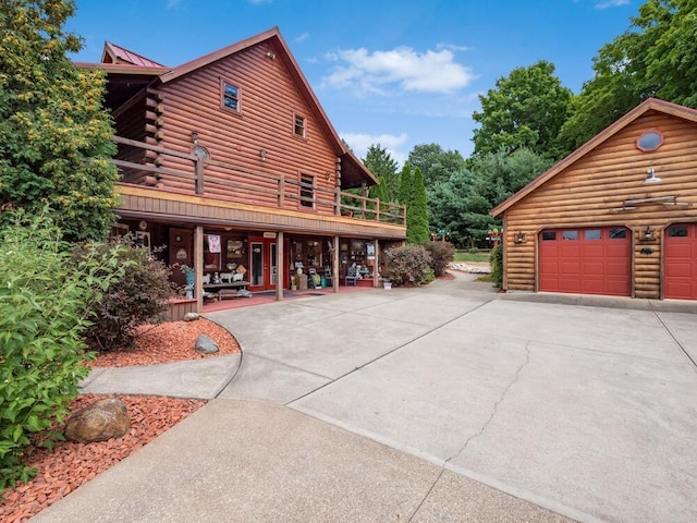 view of side of home with a porch and a garage