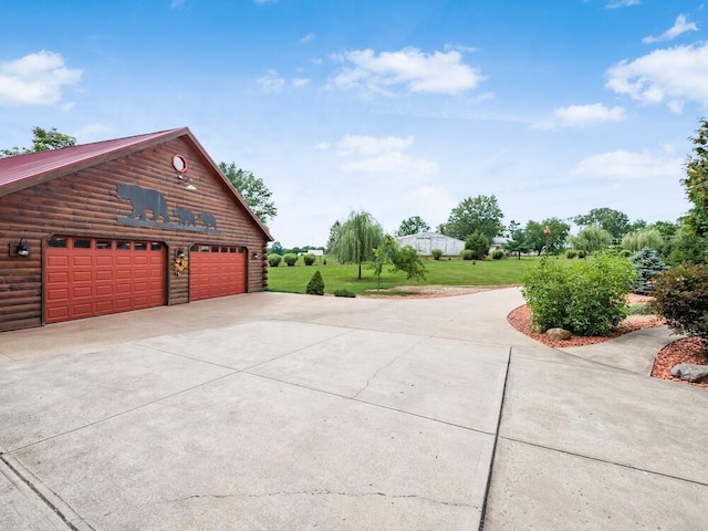 view of side of home with a garage and a lawn