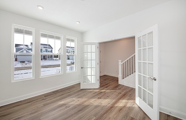 unfurnished room featuring recessed lighting, french doors, baseboards, visible vents, and wood finished floors
