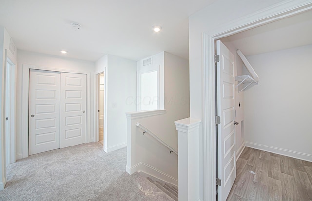 hall with recessed lighting, an upstairs landing, baseboards, and visible vents