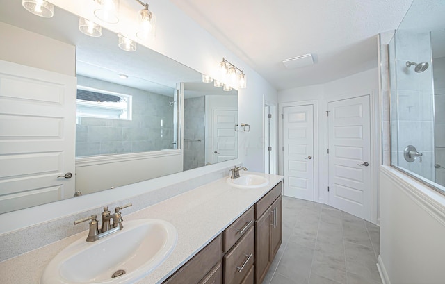 bathroom featuring double vanity, a sink, and tile patterned flooring