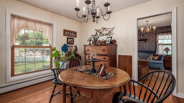 dining area featuring a notable chandelier, wood-type flooring, and baseboard heating