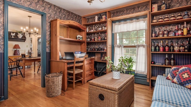 office space featuring light hardwood / wood-style flooring and an inviting chandelier