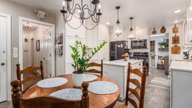 dining space with sink and a chandelier