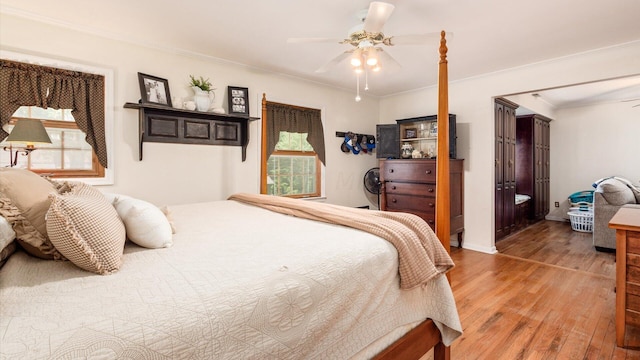 bedroom featuring ceiling fan, wood-type flooring, and ornamental molding