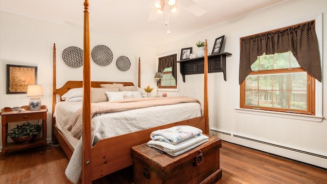 bedroom featuring wood-type flooring, baseboard heating, ornamental molding, and ceiling fan