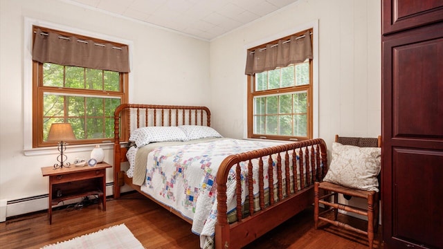 bedroom featuring multiple windows, dark hardwood / wood-style flooring, and ornamental molding