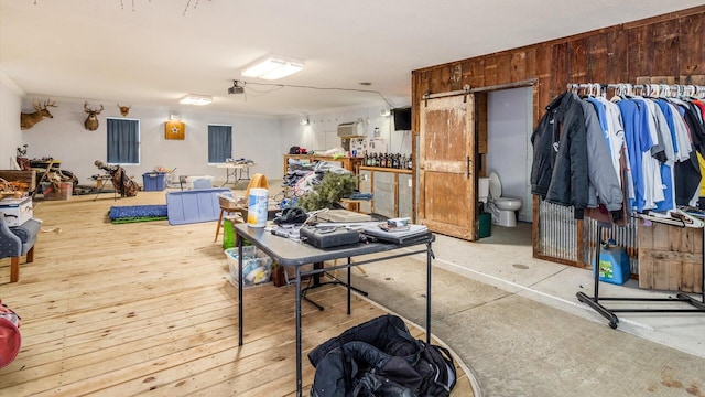 interior space with light hardwood / wood-style flooring and wooden walls