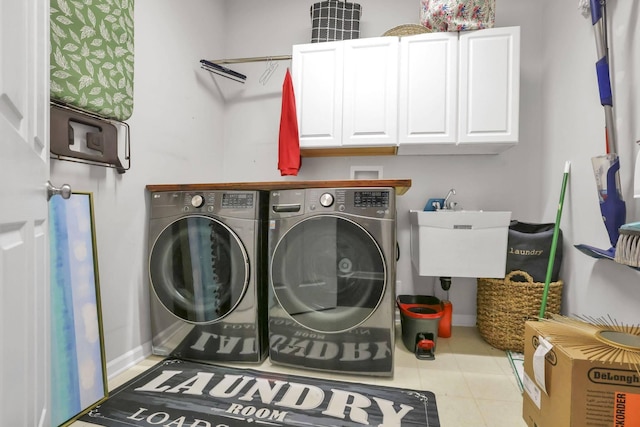 clothes washing area with cabinets, light tile patterned floors, separate washer and dryer, and sink