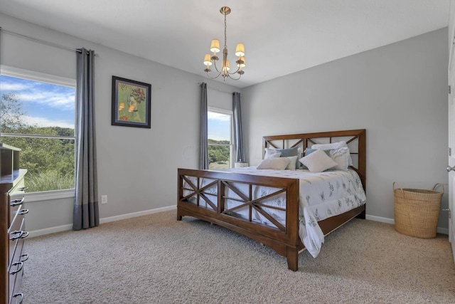 carpeted bedroom featuring a notable chandelier