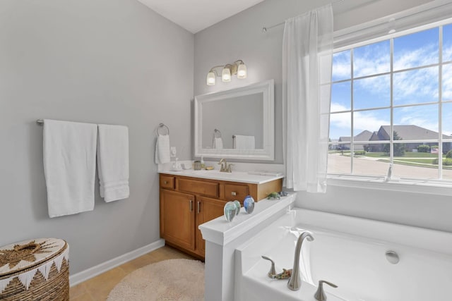 bathroom with vanity, tile patterned floors, and a bathtub