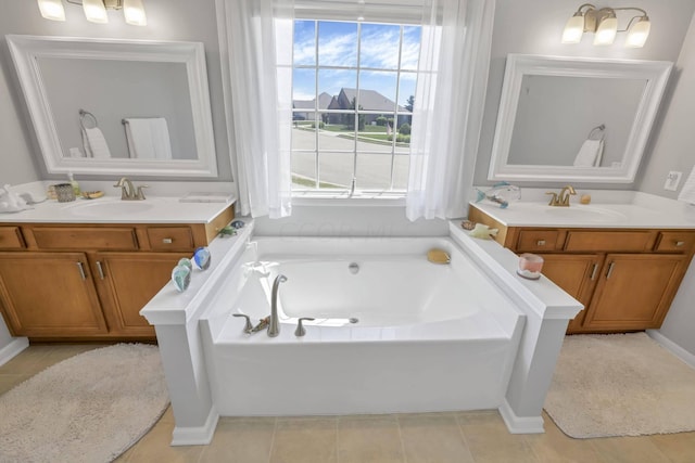 bathroom featuring tile patterned floors, vanity, and a bathing tub