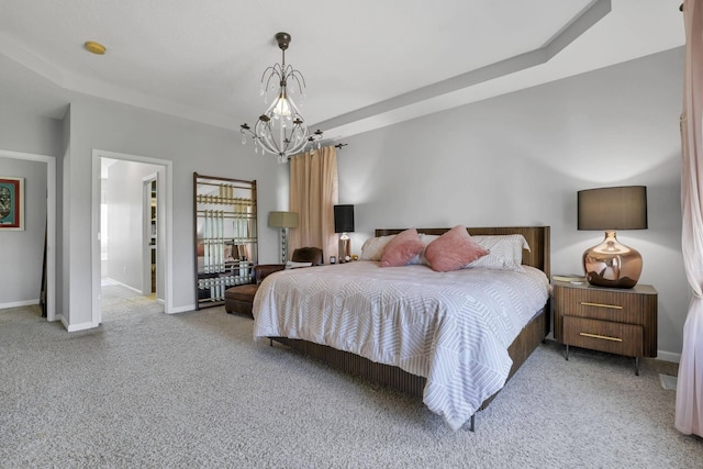 carpeted bedroom featuring ensuite bath and a notable chandelier