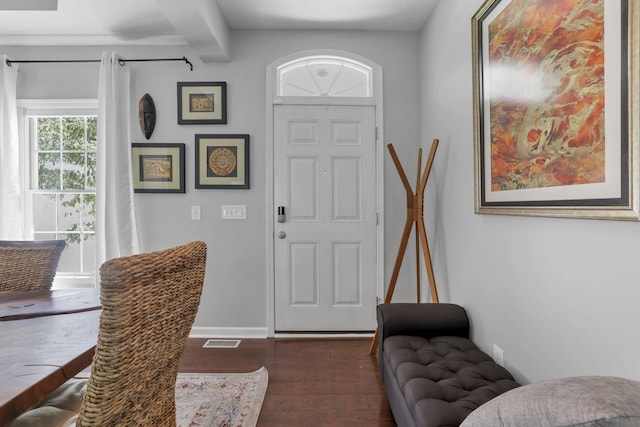 entrance foyer featuring dark hardwood / wood-style flooring and beamed ceiling