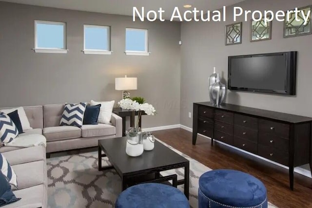 living room with dark hardwood / wood-style floors and a wealth of natural light