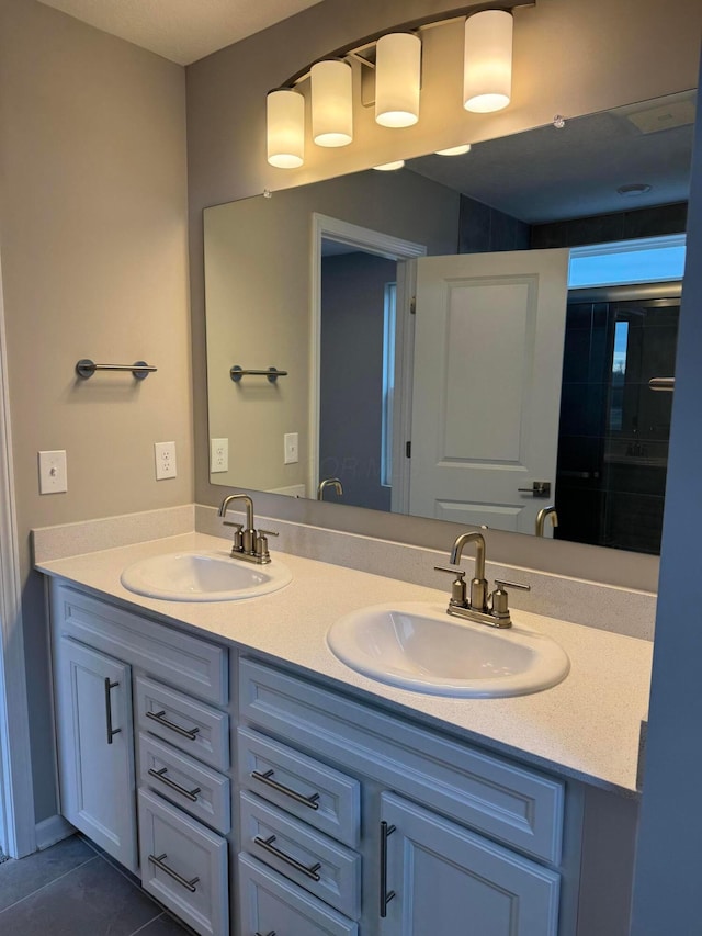 bathroom with tile patterned floors and vanity