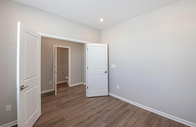 unfurnished bedroom featuring dark hardwood / wood-style flooring