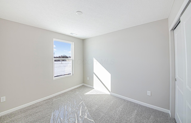 unfurnished bedroom with a textured ceiling, light carpet, and a closet