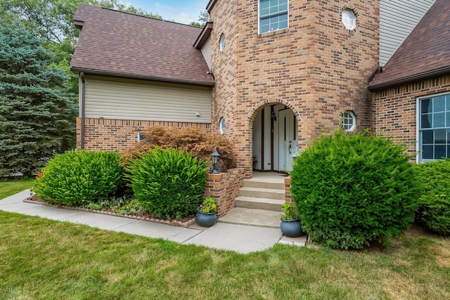 doorway to property featuring a yard