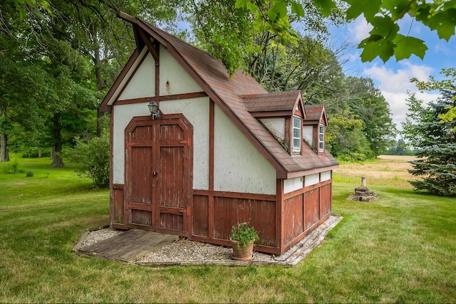 view of outbuilding featuring a lawn