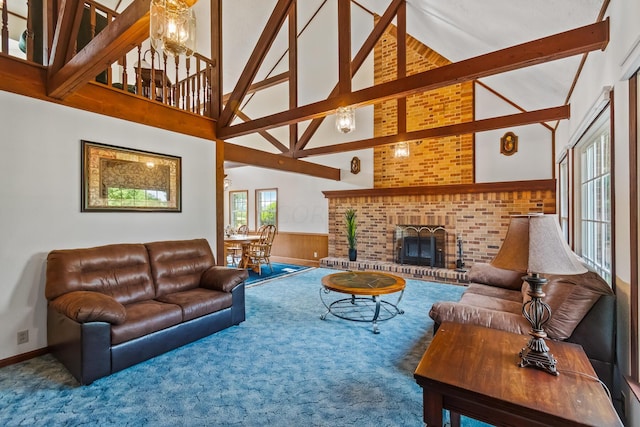 carpeted living room featuring beamed ceiling, high vaulted ceiling, and a fireplace