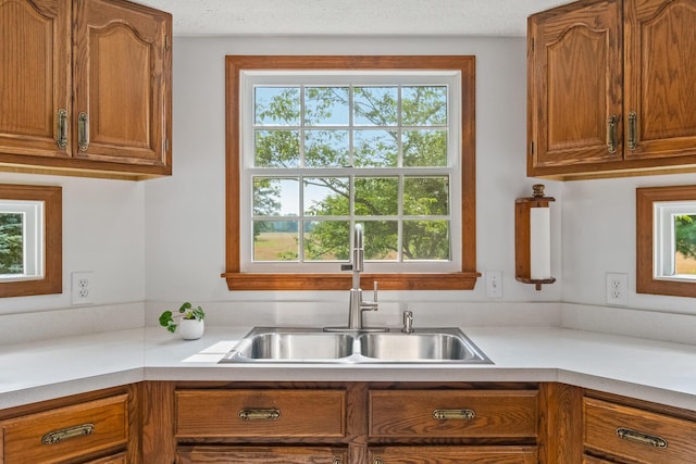 kitchen featuring a textured ceiling and sink