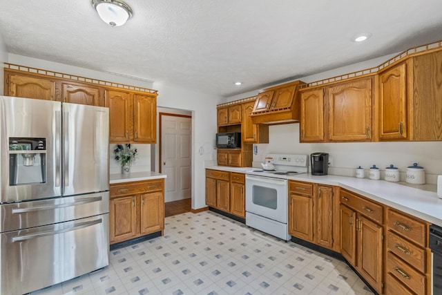 kitchen with white range with electric stovetop, stainless steel fridge, and a textured ceiling