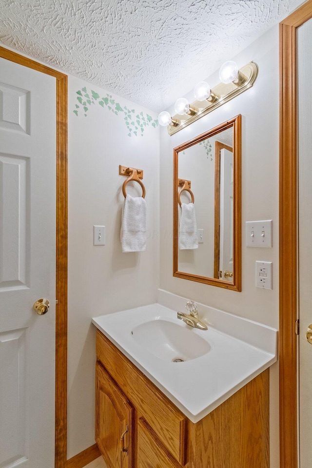 bathroom with vanity and a textured ceiling