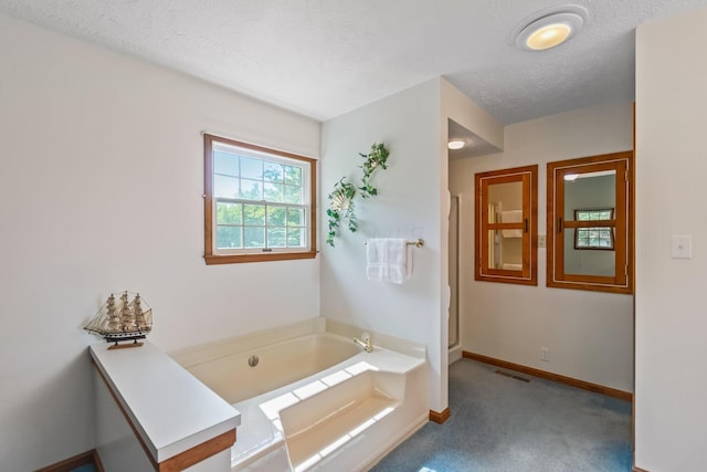 bathroom featuring a bathtub and a textured ceiling