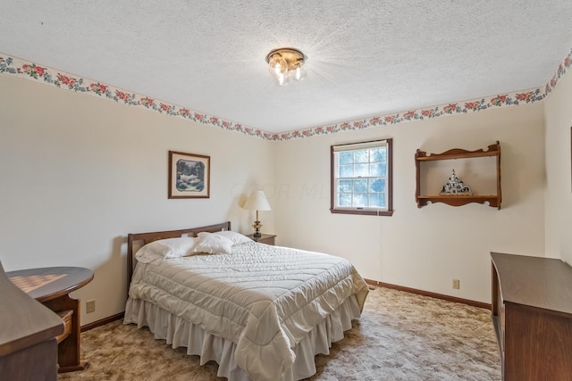 bedroom with light carpet and a textured ceiling