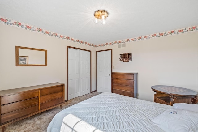 bedroom featuring light colored carpet and a closet