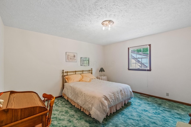 carpeted bedroom featuring a textured ceiling