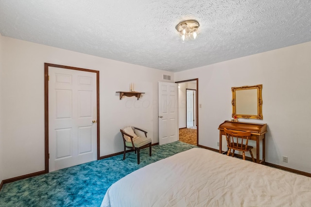 carpeted bedroom featuring a textured ceiling