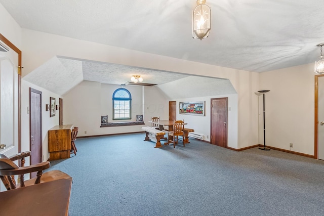 sitting room featuring carpet, a textured ceiling, and vaulted ceiling