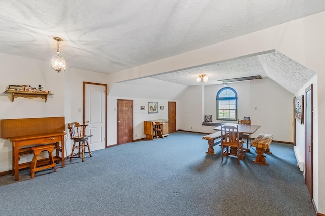 dining room with carpet, a textured ceiling, an inviting chandelier, and lofted ceiling