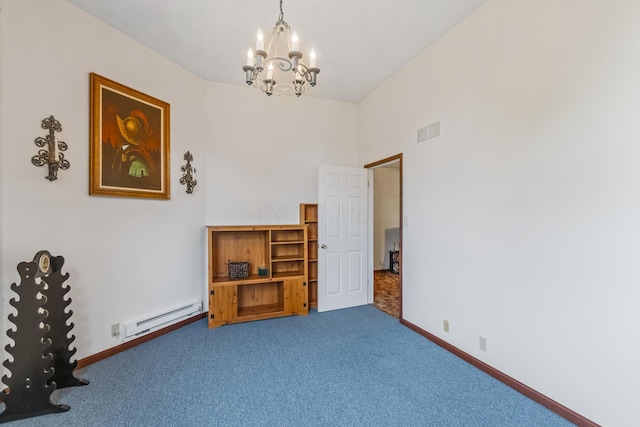 spare room featuring carpet flooring, a notable chandelier, and baseboard heating