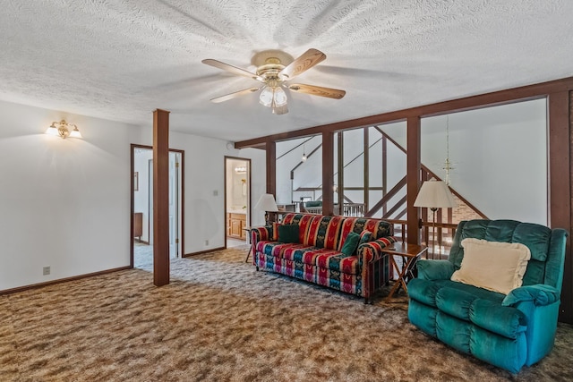 carpeted living room featuring ceiling fan and a textured ceiling