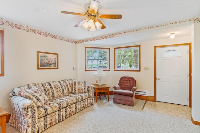 carpeted living room with ceiling fan and a baseboard heating unit