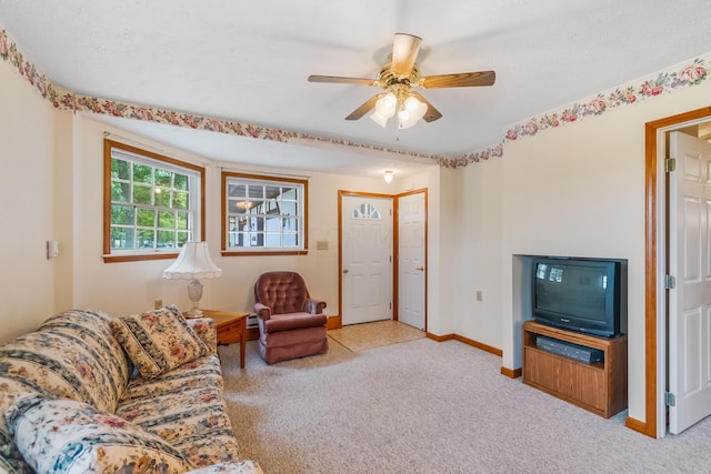 carpeted living room featuring ceiling fan