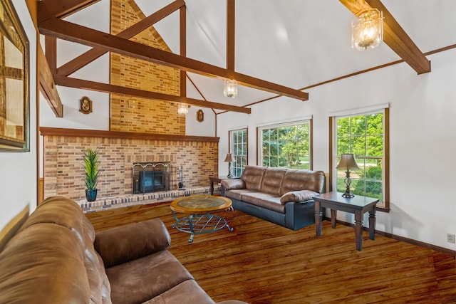 living room with beam ceiling, wood-type flooring, high vaulted ceiling, and a brick fireplace