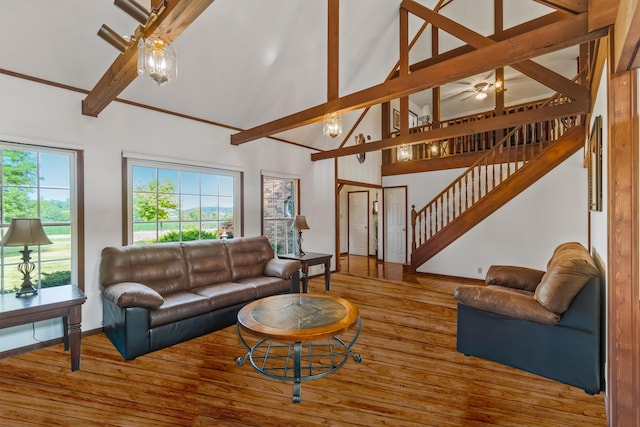 living room with beam ceiling, high vaulted ceiling, and wood-type flooring