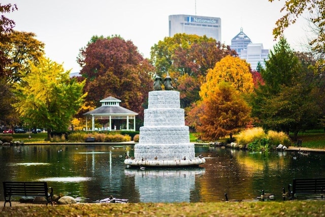 surrounding community with a gazebo and a water view