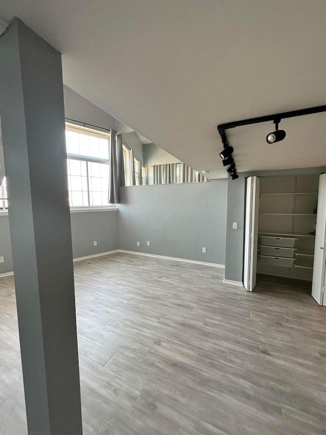 interior space with light hardwood / wood-style flooring and lofted ceiling