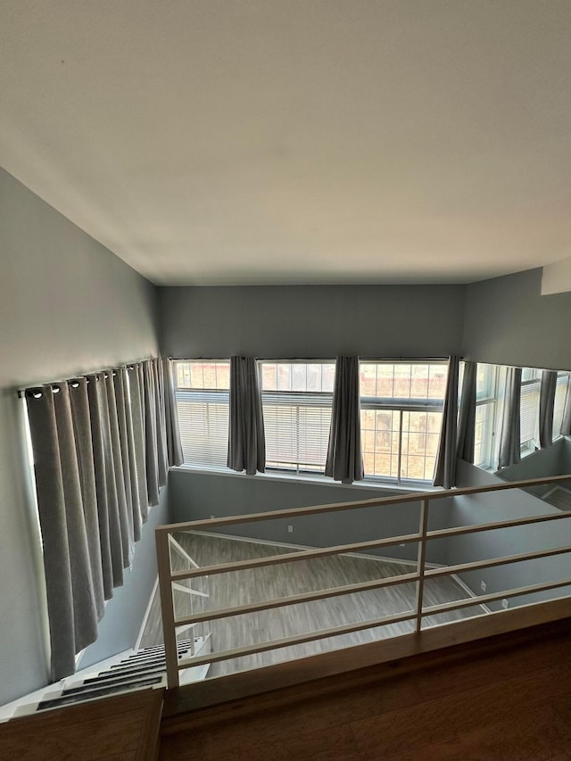 stairs with hardwood / wood-style flooring