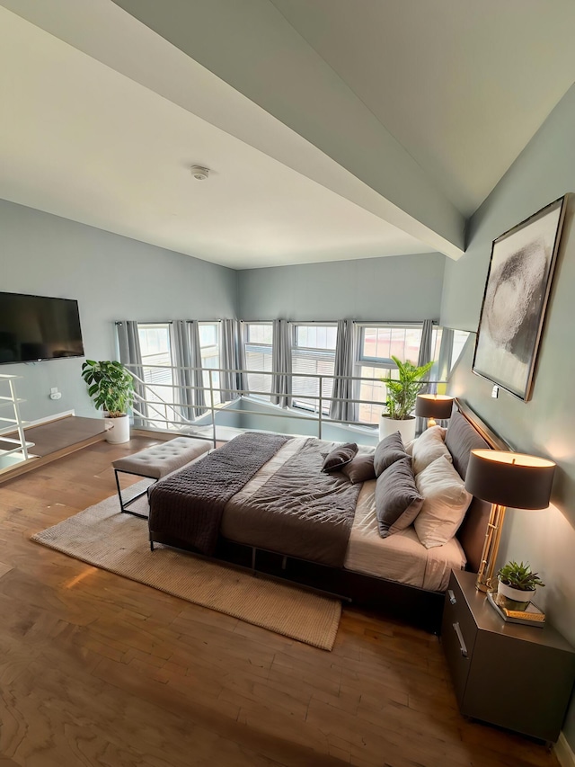 bedroom featuring hardwood / wood-style flooring and lofted ceiling