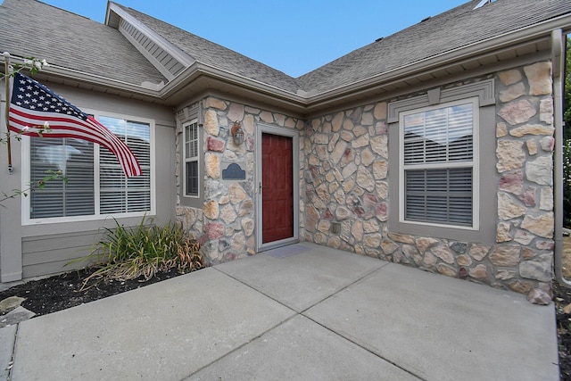 view of exterior entry featuring a patio area