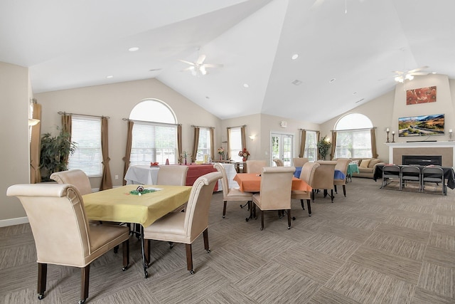 dining space with ceiling fan, light carpet, and lofted ceiling